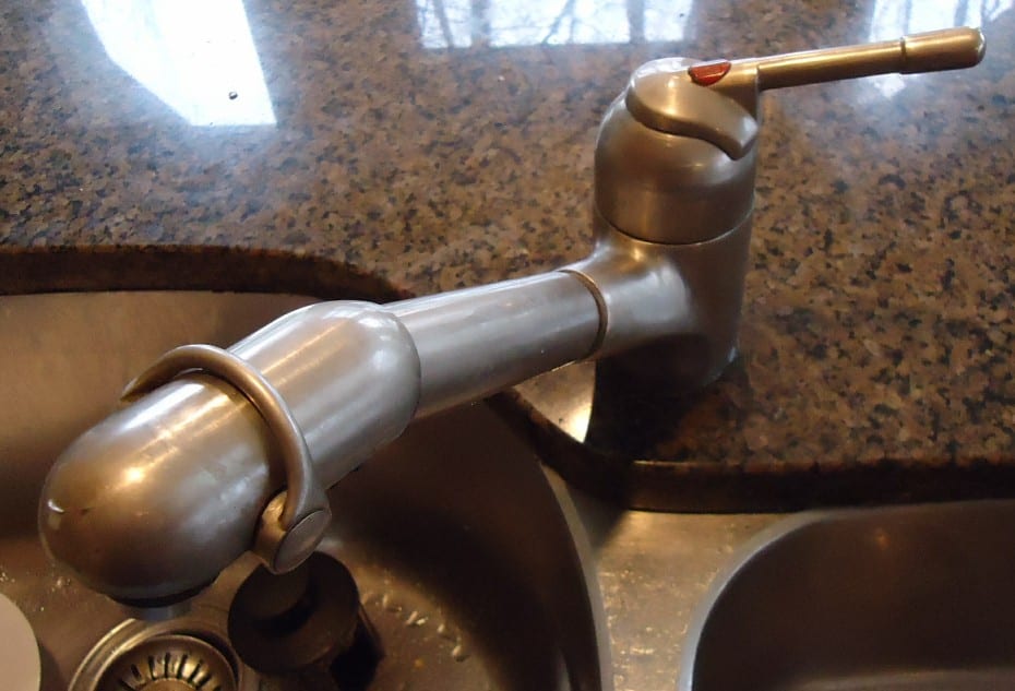 Single-lever kitchen faucet beside a stainless steel sink
